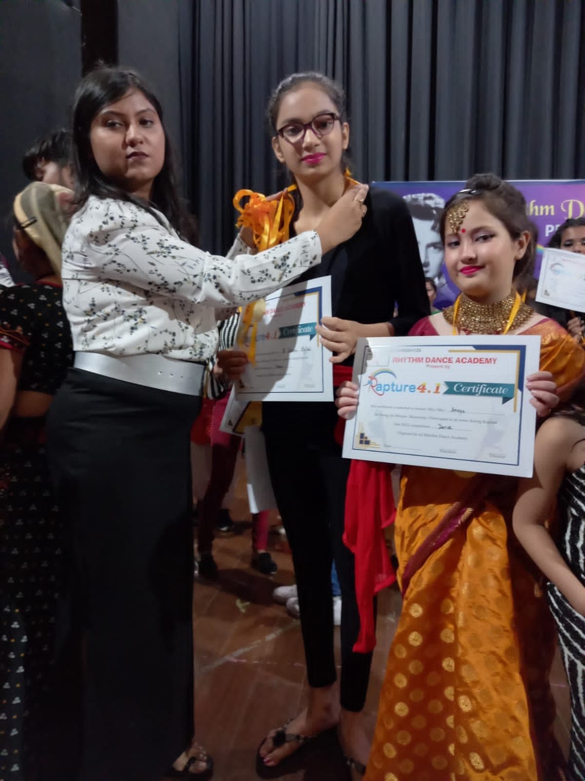 Senior dance students receiving certificates after a competition