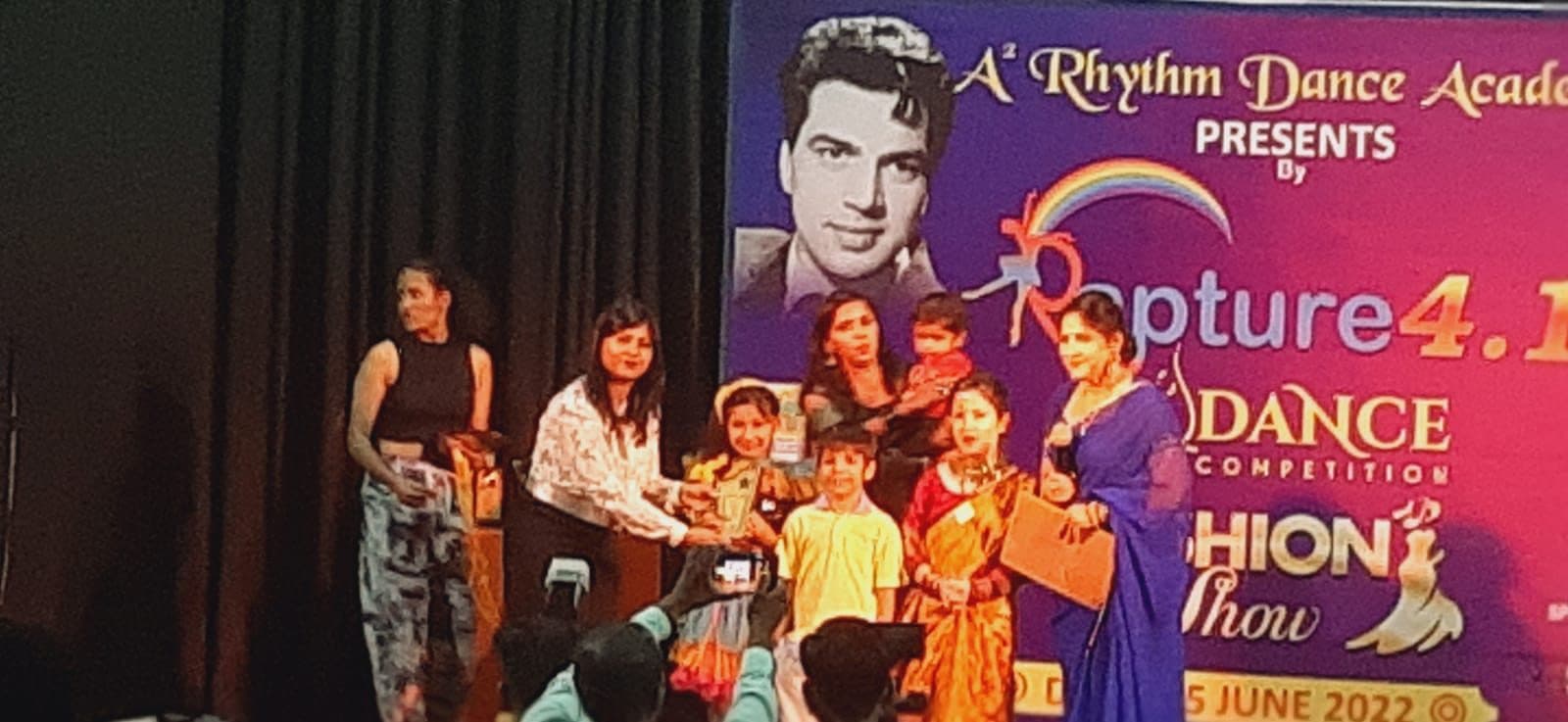 Dance competition stage with young performers receiving prizes