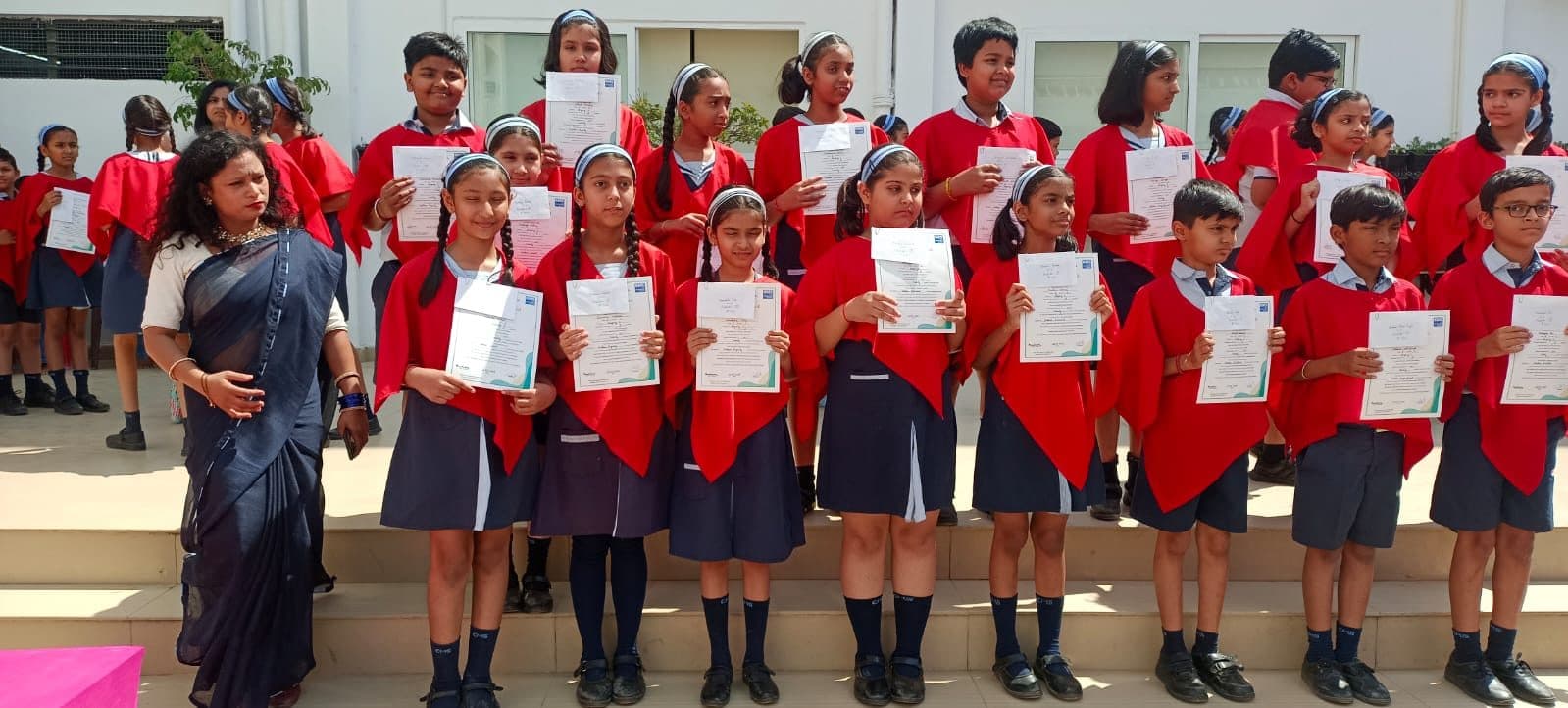 Students holding their olympiad achievement certificates
