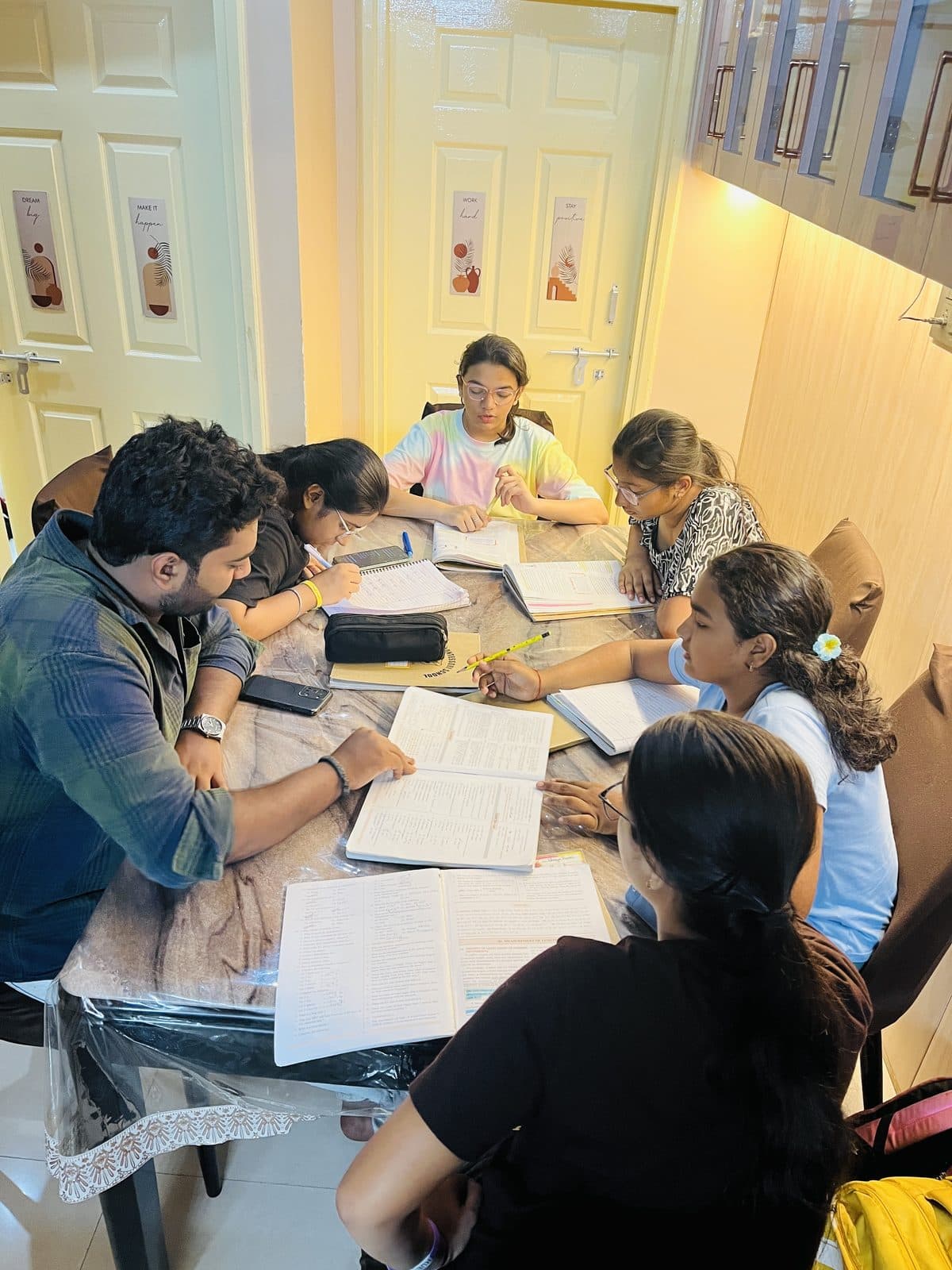 Senior students taking notes during a board exam batch