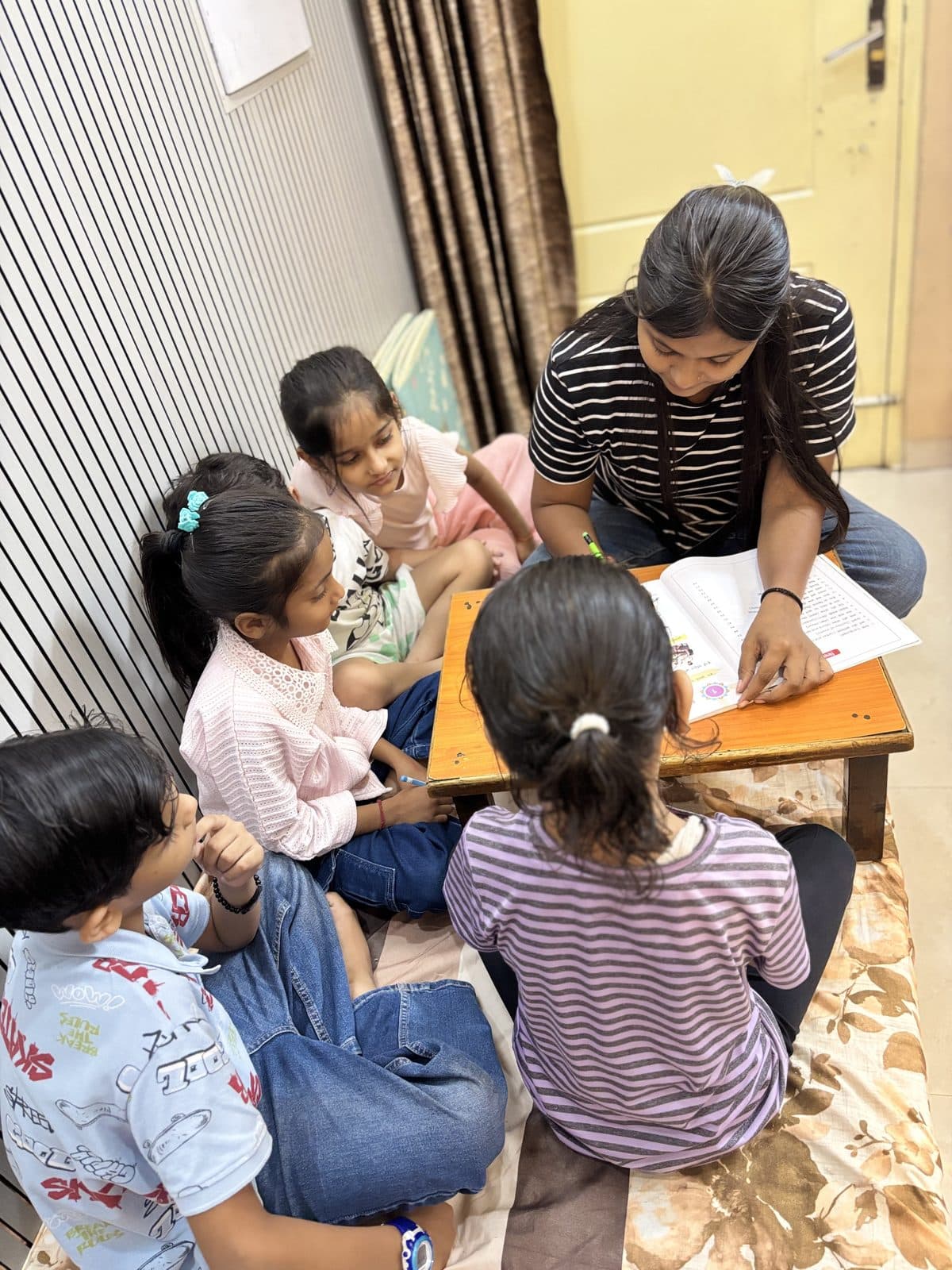 Primary students seated in a circle during a reading session