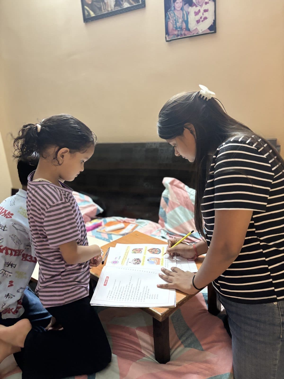 Teacher working one-on-one with a young student at a study desk